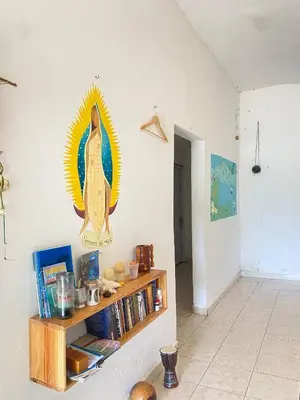 a living room with a bird on the wall at Bed-Breakfast lunch Tropical Private-room in Santa Bárbara de Samaná