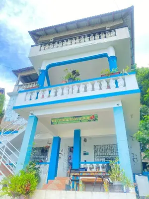 a blue and white building with a table outside at Bed-Breakfast lunch Tropical Private-room in Santa Bárbara de Samaná