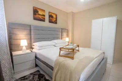 a bedroom with a bed with a table on it at Studio 3 Zona Colonial - Centro Histórico in Santo Domingo