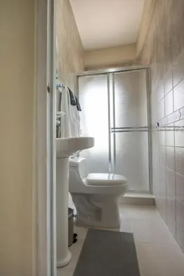 a bathroom with a toilet and a sink and a shower at Studio 3 Zona Colonial - Centro Histórico in Santo Domingo