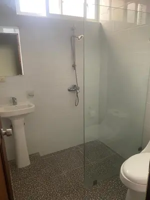 a bathroom with a glass shower with a toilet and a sink at Hotel Down Town Cabrera in Cabrera