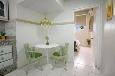 a dining room with a white table and chairs at Estudio 2 Conde 504 at Historic Main Street in Santo Domingo
