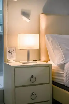 a lamp on a night stand next to a bed at Estudio 2 Conde 504 at Historic Main Street in Santo Domingo