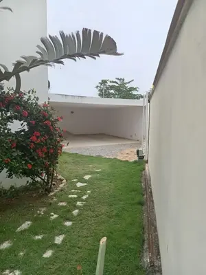 a backyard with a white fence and a yard with grass at Villa Langosta in Las Terrenas