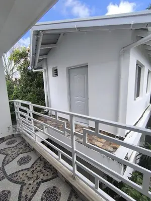 a balcony of a white building with a door at Room Vanesa in Las Terrenas