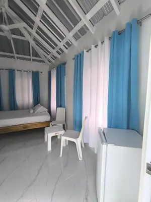 a room with a bed and a table and a chair at Room Vanesa in Las Terrenas