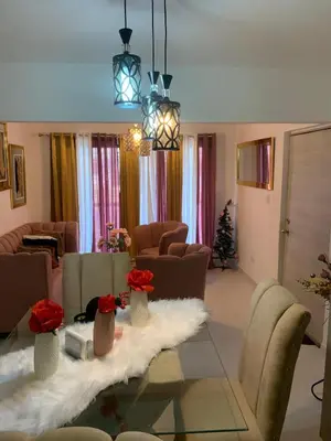 a living room with a table with flowers on it at Residencial habitat uno in Los Paredones
