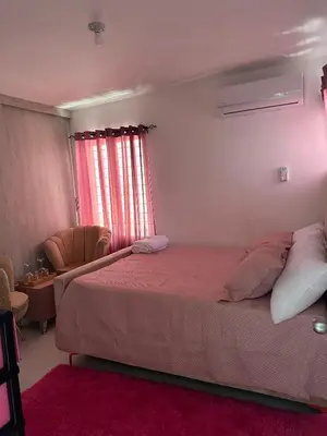 a bedroom with a bed and a chair and a window at Residencial habitat uno in Los Paredones