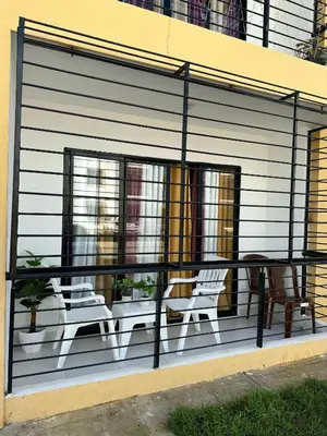 a screened in porch with two chairs and a table at Residencial habitat uno in Los Paredones