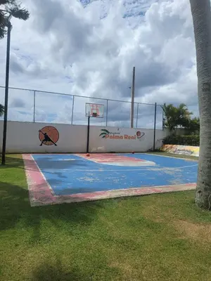 a basketball court in a park with a fence at Palma Real Apt Near Cibao Airport & Pool in Santiago de los Caballeros