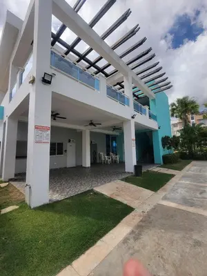a view of a building with a pergola at Palma Real Apt Near Cibao Airport & Pool in Santiago de los Caballeros