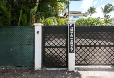a black fence with a gate with a sign on it at Casa Zelima, a fully equipped apartment in Las Terrenas
