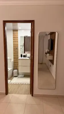 a bathroom with a sink and a toilet and a mirror at Cozy and Beautiful, 3 Bedroom Apartment Home in Santo Domingo