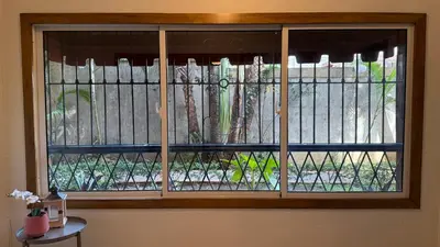 a window with a view of a fence at Cozy and Beautiful, 3 Bedroom Apartment Home in Santo Domingo