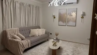 a living room with a couch and a table at Cozy and Beautiful, 3 Bedroom Apartment Home in Santo Domingo