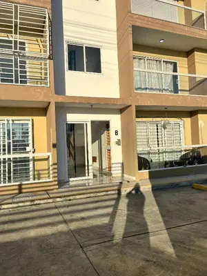 a shadow of a person walking in front of a building at Ocean View Apartment in Santo Domingo Este in La Viva