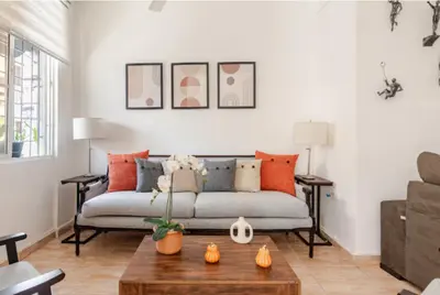 a living room with a couch and a table at SDQ Colonial Zone an great find in Santo Domingo