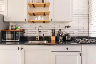 a kitchen counter with white cabinets and a sink at SDQ Colonial Zone an great find in Santo Domingo