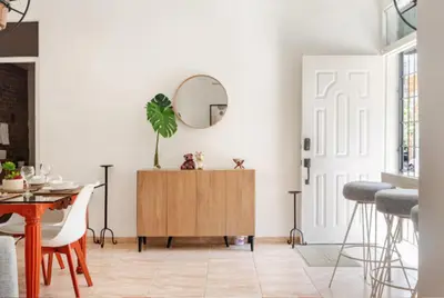 a living room with a table and a mirror at SDQ Colonial Zone an great find in Santo Domingo