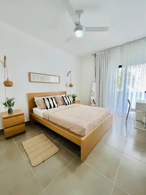 a bedroom with a bed and a ceiling fan at Caribbean dream in Punta Cana in Colorado