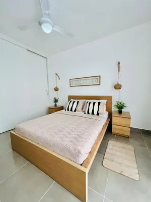 a bedroom with a bed and a white wall at Caribbean dream in Punta Cana in Colorado