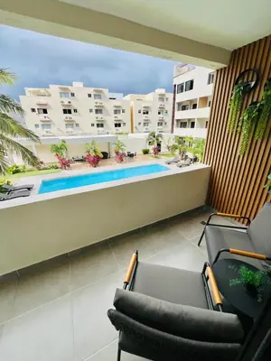 a balcony with chairs and a swimming pool at Caribbean dream in Punta Cana in Colorado