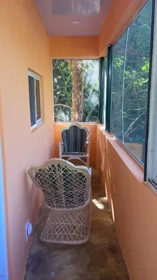 a chair sitting in a room with a window at Bargain Beach Getaway in Las Terrenas
