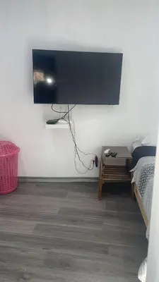 a bedroom with a tv on the wall and a bed at Bargain Beach Getaway in Las Terrenas