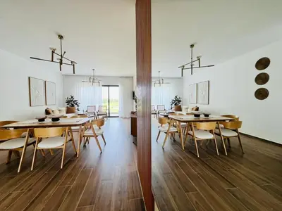 a large dining room with wooden tables and chairs at Cana Cove in Punta Cana