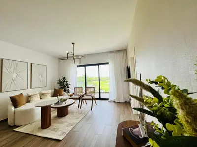 a living room with a couch and a table at Cana Cove in Punta Cana