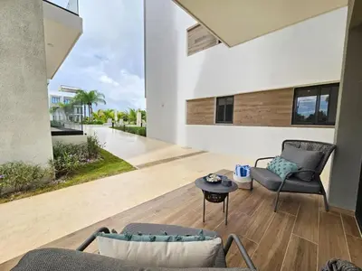 a living room with two chairs and a table at Cana Cove in Punta Cana
