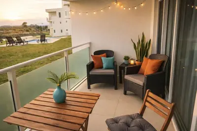 a balcony with two chairs and a table and a tableablish at Laguna del Sol in Sosúa