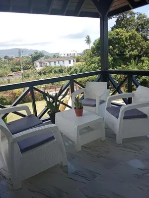 a group of chairs and a table on a porch at Villas Reynoso, Near La Playita Beach in Las Galeras Samaná in Las Galeras