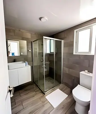 a bathroom with a shower and a toilet and a sink at Condominio privado con piscina, cerca de la playa in Punta Cana