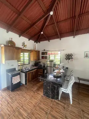 a large kitchen with a table and chairs in it at Rancho La Loma in Higuey