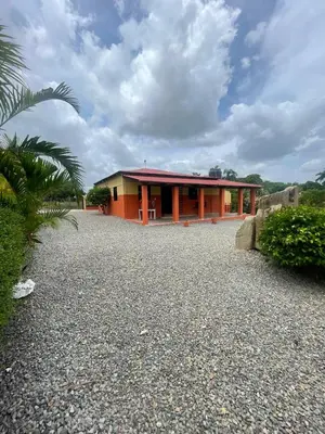 a house with a gravel driveway in front of it at Rancho La Loma in Higuey
