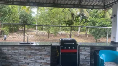 a grill in a patio with a view of a yard at Farm Escape in Colorado