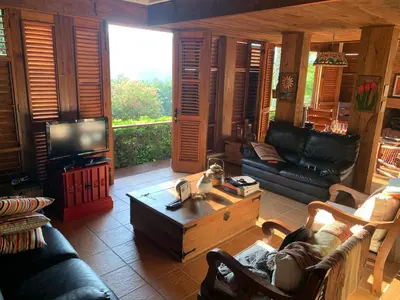 a living room with a couch and a coffee table at Villa del Pino en Quintas del Bosque in Jarabacoa
