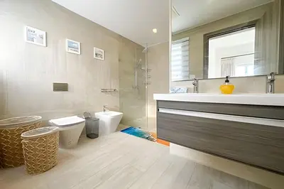a bathroom with a sink and a toilet and a mirror at Cana Pearl Fase I y II in Punta Cana