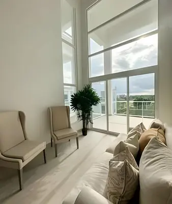 a living room with a couch and chairs and a window at Cana Pearl Fase I y II in Punta Cana