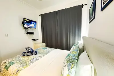 a bedroom with a bed with a television in it at Alojamientos de 1 y 2 habitaciones a 5 min de la playa in Punta Cana