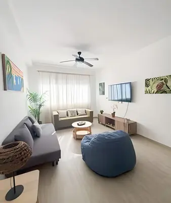a living room with a couch and a table at Coral Village II in Punta Cana