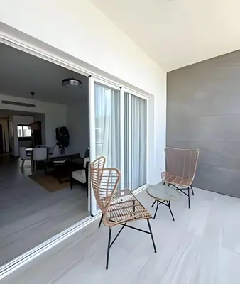a living room with chairs and a table at Alojamientos en Coral Bay II Cerca del Hard Rock Hotel Punta Cana in Punta Cana