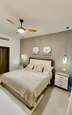a bedroom with a large bed and a ceiling fan at Alojamientos en Coral Bay II Cerca del Hard Rock Hotel Punta Cana in Punta Cana