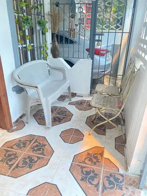 a patio with a table and chairs on a tile floor at Recidencial sharael house in San Isidro