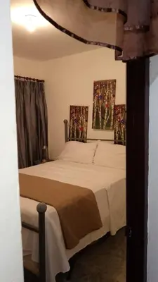 a bedroom with a bed and two posters on the wall at Recidencial sharael house in San Isidro