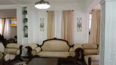 a living room with a couch and two chairs at Recidencial sharael house in San Isidro