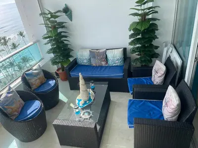a living room with couches and a table and plants at Beachfront Three Bedroom apt with Jacuzzi in Juan Pedro