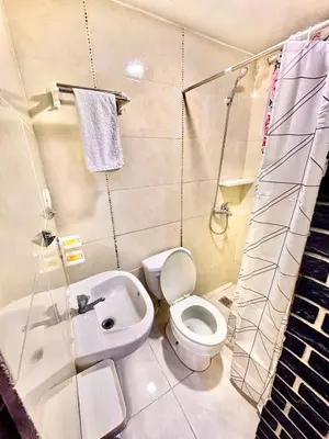 a bathroom with a toilet and a sink at Aparta El Mundo in Punta Cana