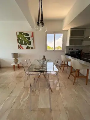 a dining room with a glass table and chairs at PentHouse Jakuzzi Hotel Hard Rock in Punta Cana